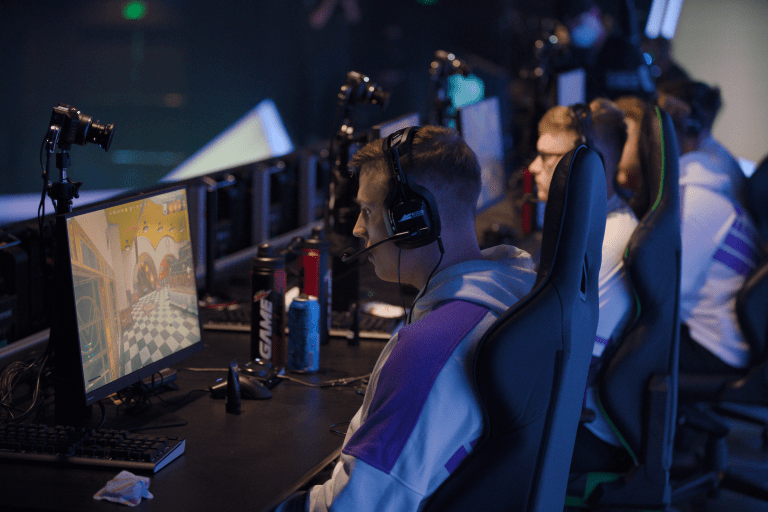 CleanX competing on-stage in the Call of Duty League with the Toronto Ultra, intensely looking at his monitor.