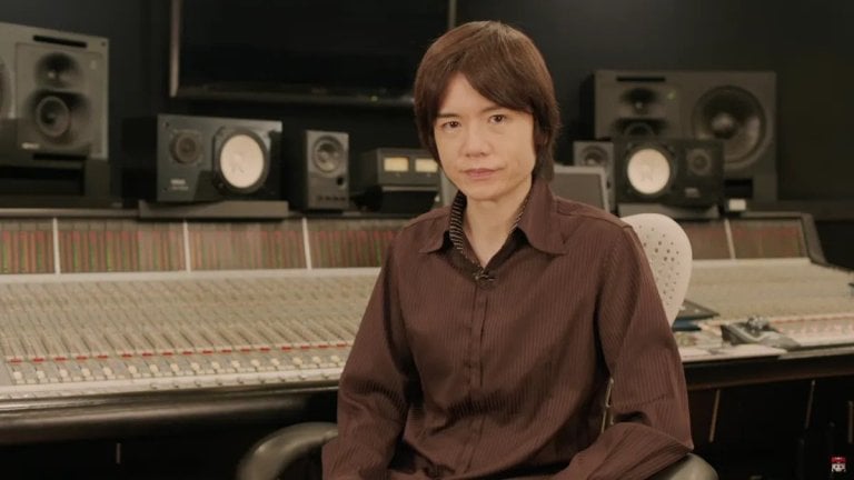 Sakurai sits, looking at a camera.