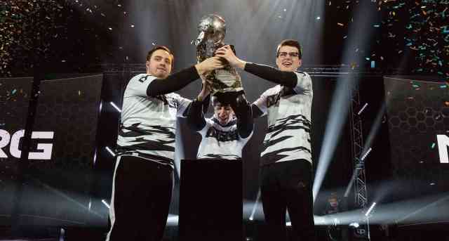 jstn, GarretG, and Turbopolsa lifting a trophy with NRG
