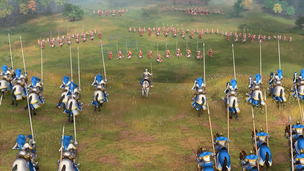 An army in blue armor ready to charge on an army with red armor across a field of grass with trees in the background