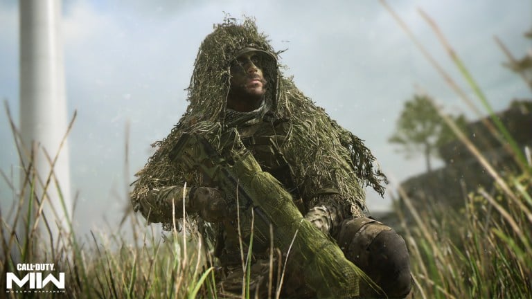 A character wearing a ghillie suit full of grass holding a sniper rifle in Call of Duty.