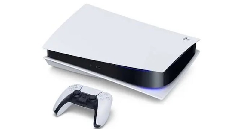 A PS5 lying on its side with a controller next to it.