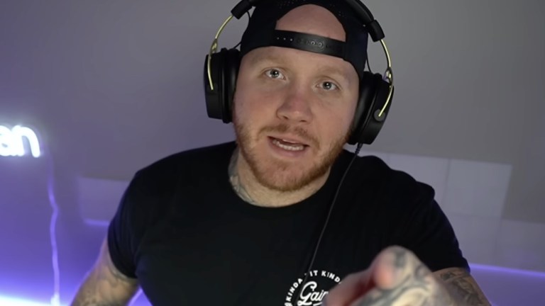 TImTheTatman on stream looking directly at the camera weaing a backwards baseball cap and black t-shirt