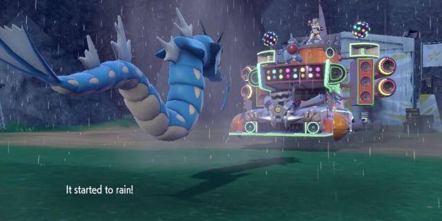 Gyarados facing a Pokémon boss with rain in a grass field.