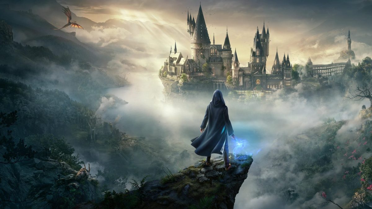 A wizard stands looking at Hogwarts in the distance