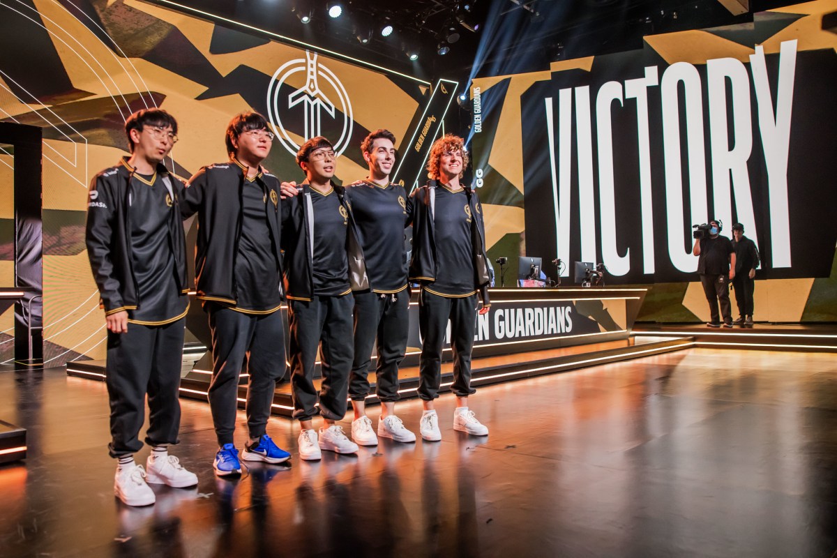 Golden Guardians' 2023 LCS roster on stage after a victory.