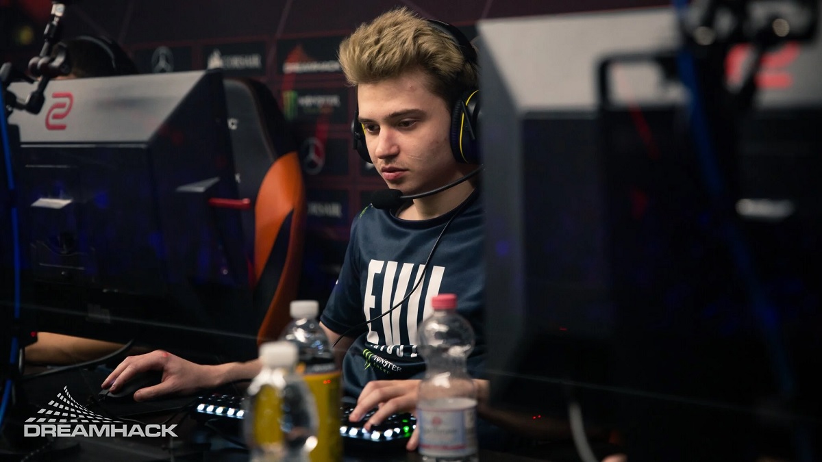 Ramzes sits at a computer with a headset on.