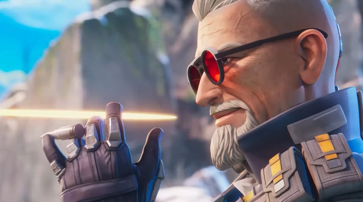 Ballistic twirls a bullet between his fingers and looks ahead through his red-tinted glasses while a bullet whizzes by.