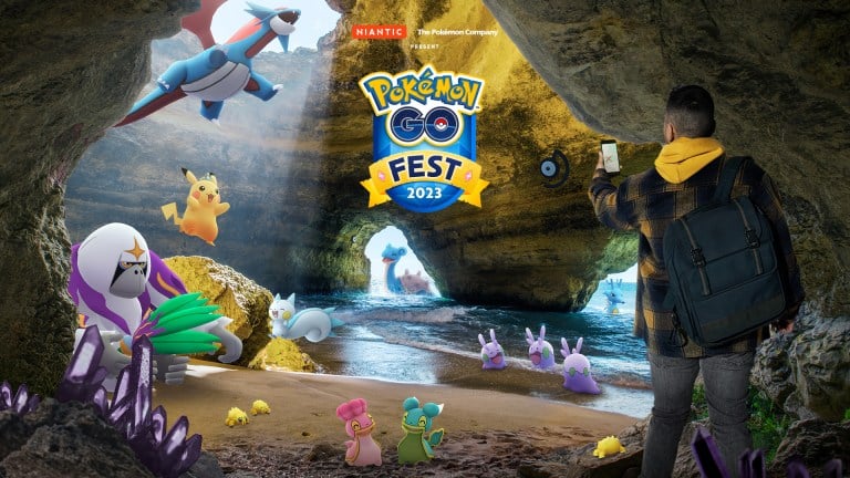 An image depicting the Pokémon that will appear in the global celebration of the 2023 Pokémon Go Fest, including Oranguru, both forms of Shellos, Joltik, Goomy, Lapras, Pachirisu, Unown, Kingdra, Salamence, and Pikachu wearing a crown. They all appear in a beachside cave with various pink gems in the sand.