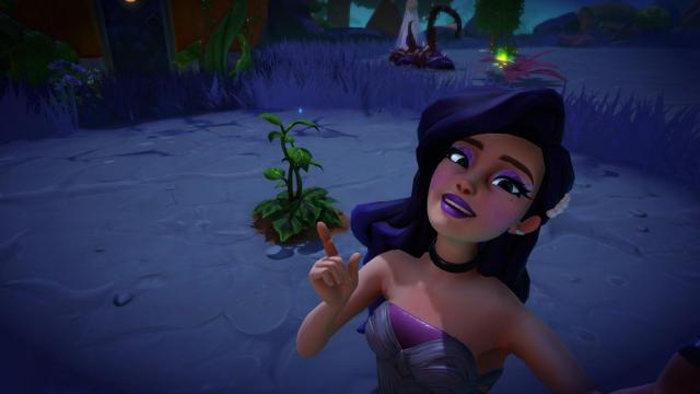 The player taking a selfie with the Green Potato plant in the Forgotten Lands biome.