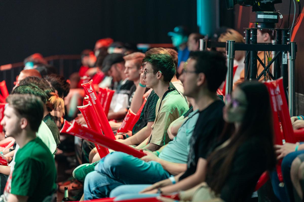 People sitting in a crowd at an LEC event.