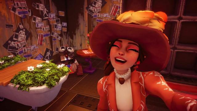 The player wearing the new dress and one of the hats the Wall-E bundle includes with Wall-E wearing his new outfit in the background.