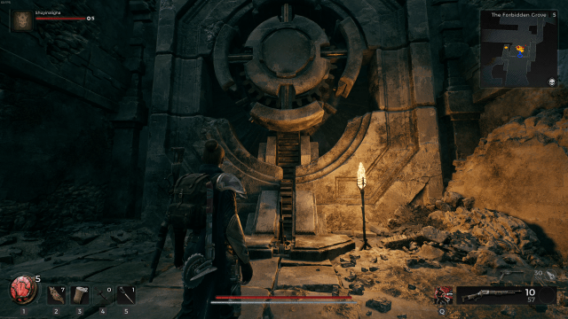 The player character in Remnant 2 stands in front of a gear-shaped cutout in stone. A thin lever can be seen in front of the cutout.