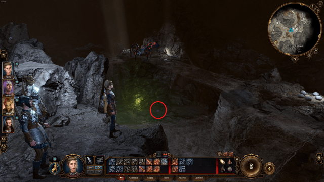 A red circle surrounds a small, purple item on the floor of a cavern in Baldur's Gate 3. A giant red and black spider looms above it.