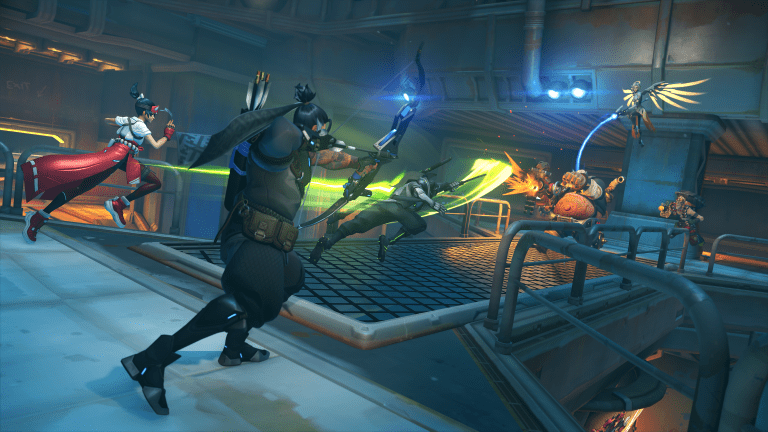 Two Overwatch teams fighting on a bridge in the Flashpoint map New Junk City.