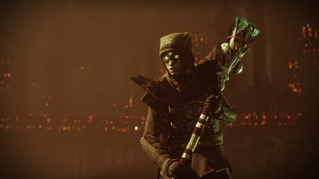 Destiny 2's Eris Morn is carrying Season of the Witch's seasonal artifact, a Hive totem made of bone and ribbon and glowing green.