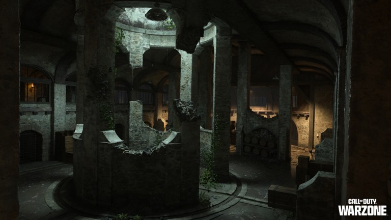 An underground cistern on Vondel in Call of Duty, with damaged stone columns and moss growing around the pillars. A small cellar sits at the opposite side of the room.