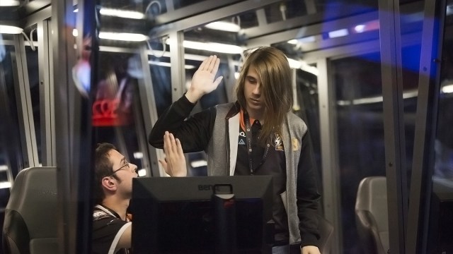 Fng, support and captain for Dota 2 squad Virtus Pro, hi-fiving a teammate at The International 2015.