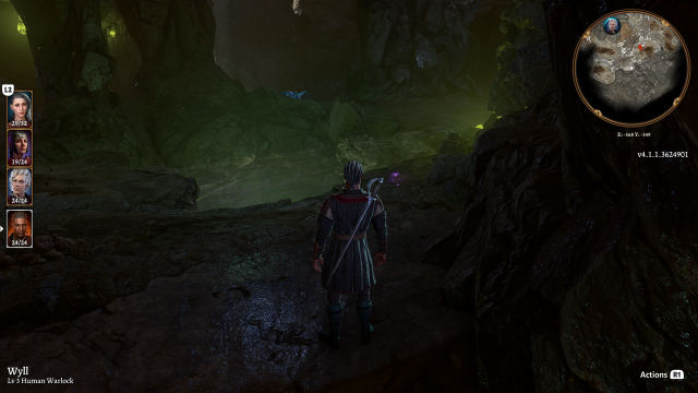 A glowing green chasm reveals itself in the cave in front of Wyll.