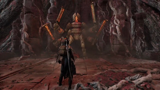 A character takes on a giant stone warrior wielding multiple swords in Remnant 2.