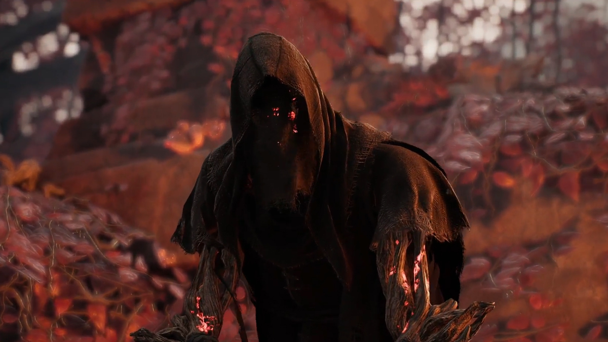 A cloaked figure screams at the character in a red forest in Remnant 2.