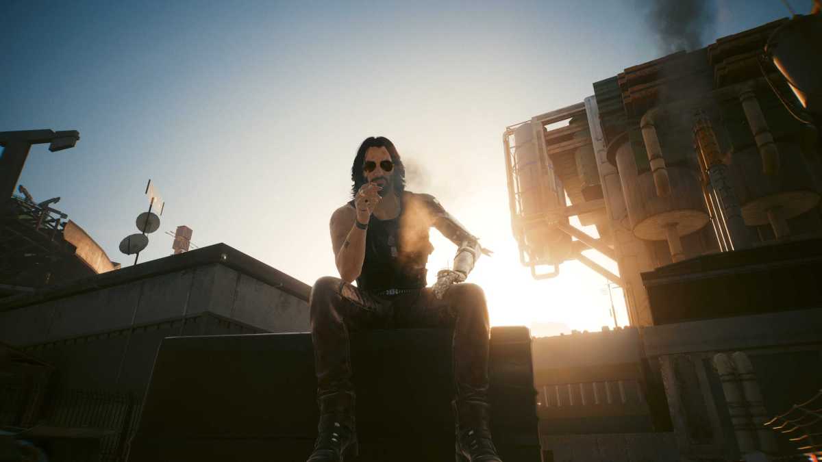 johnny silverhand sitting on a crate in cyberpunk 2077. the sun is setting behind him