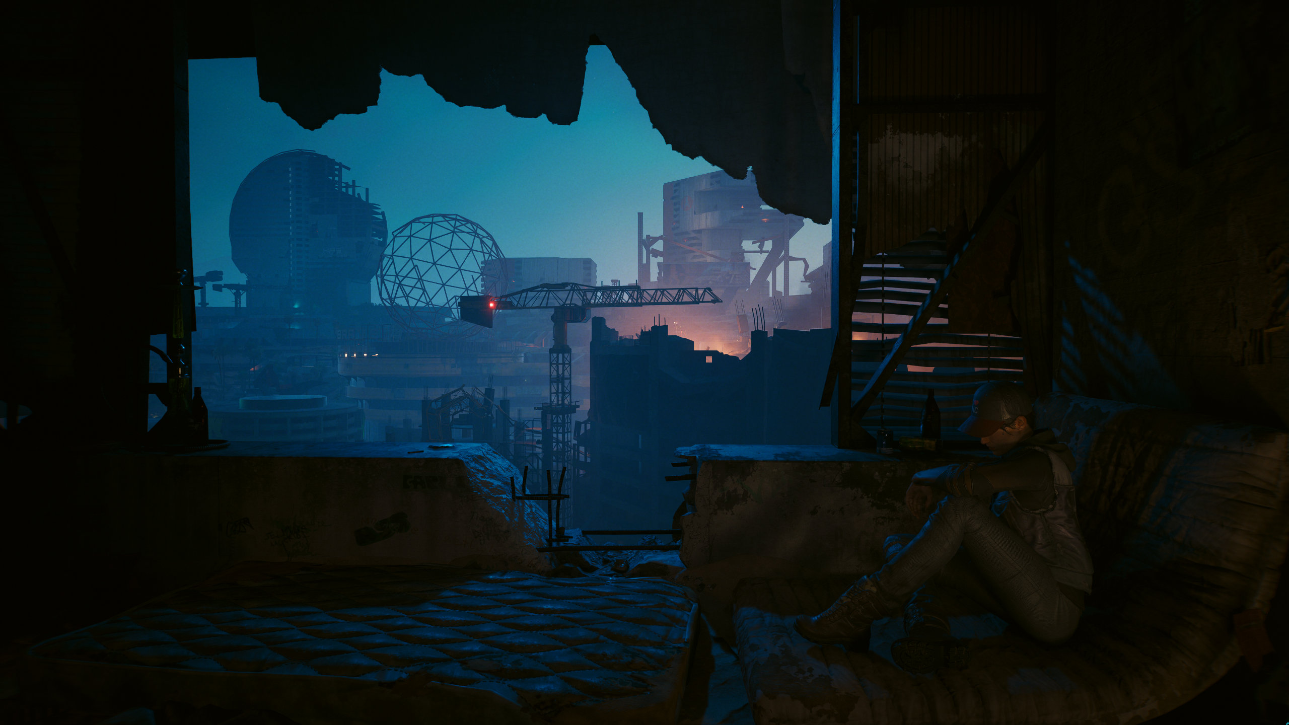 A woman resting on a mattress with a decaying city in the background in Cyberpunk 2077.