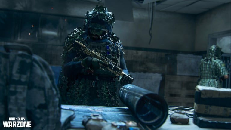 A soldier inspects his rifle as others look on in Call of Duty: Warzone.