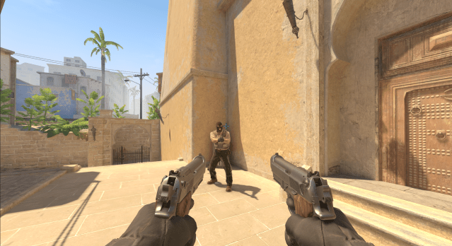 A CS2 player aims their Dual Berettas towards a Terrorist. The crosshair is light blue and big.