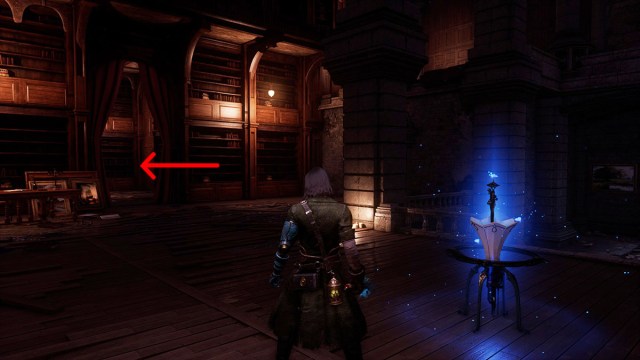 An arrow pointing to the priestess Cecile in Lies of P