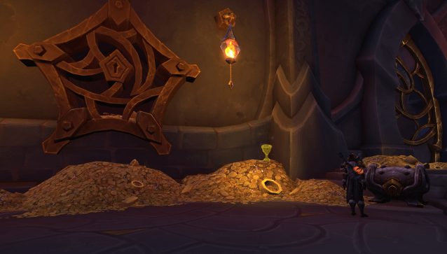The Valdrakken bank in WoW Dragonflight. A golden chalice pictured on top of a pile of gold coins. 