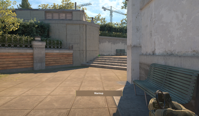 A CS2 character holding a smoke towards Fountain on Overpass.