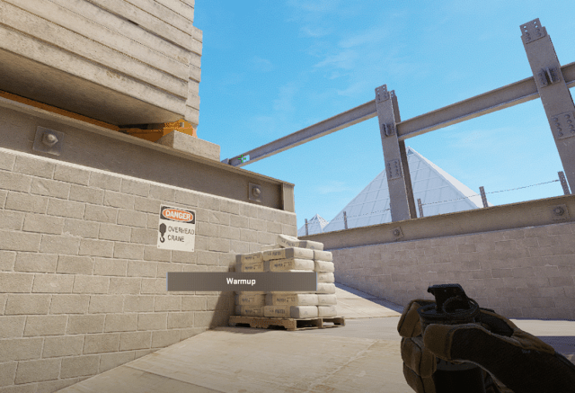 A player lines up a grenade on Vertigo in CS2.