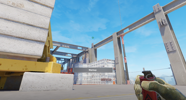 A player lines up a grenade on Vertigo in CS2.