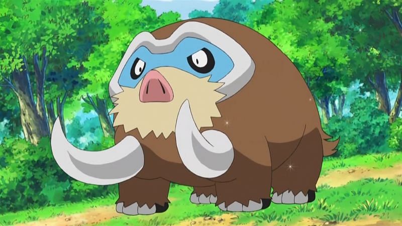 Mamoswine, a large brown Pokemon with white tusks standing in a forrest clearing. 