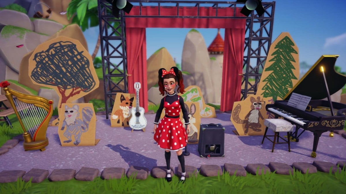 The player standing on a stage by musical instruments.