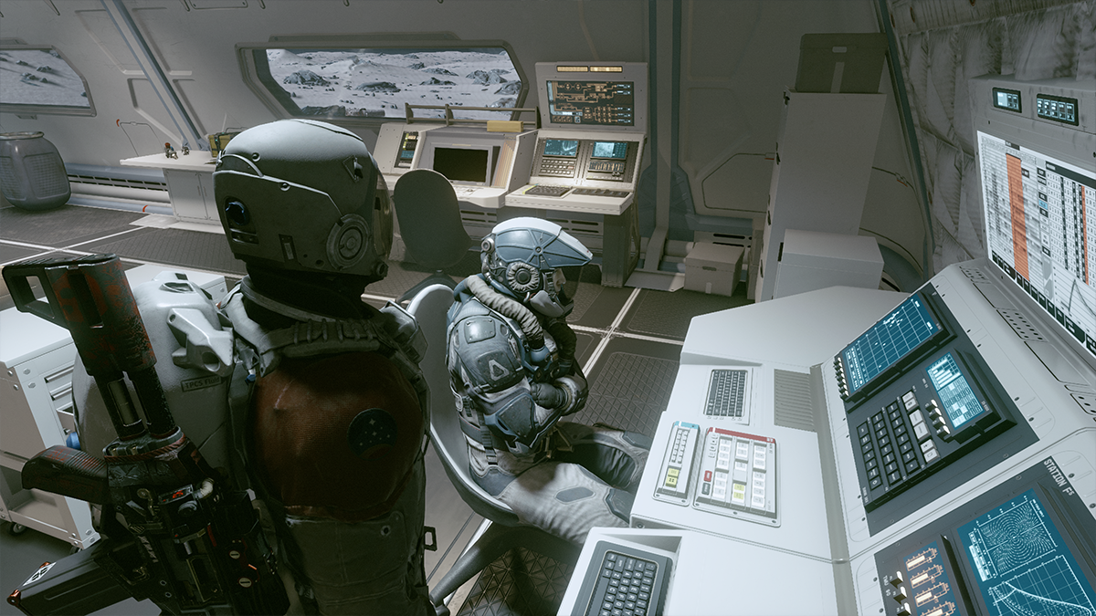 A man in a spacesuit looks at another man seated at a desk in Starfield. 