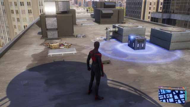 Miles Morales on a rooftop in spider-man 2 next to a tech part box