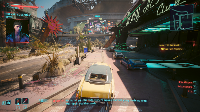 V driving a classic yellow car in Dogtown outside of the stadium while El Capitan calls (Cyberpunk 2077)