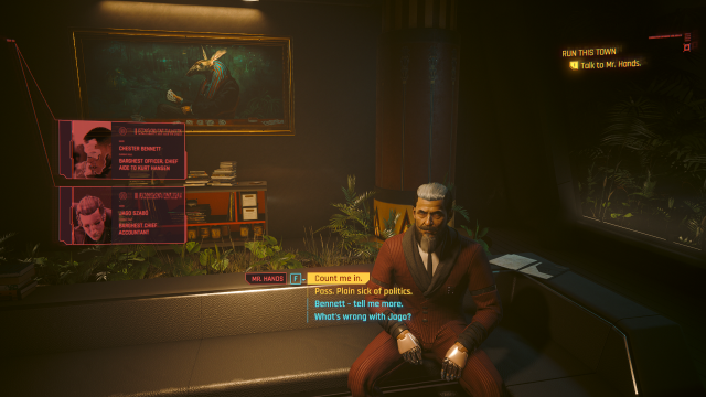 Mr Hand.s sitting on the couch in his penthouse while explaining Jago and Bennett to V (Cyberpunk 2077).