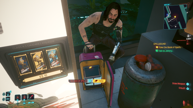 The Book of Spells in a pink suitcase and Johnny sitting behind it (Cyberpunk 2077).