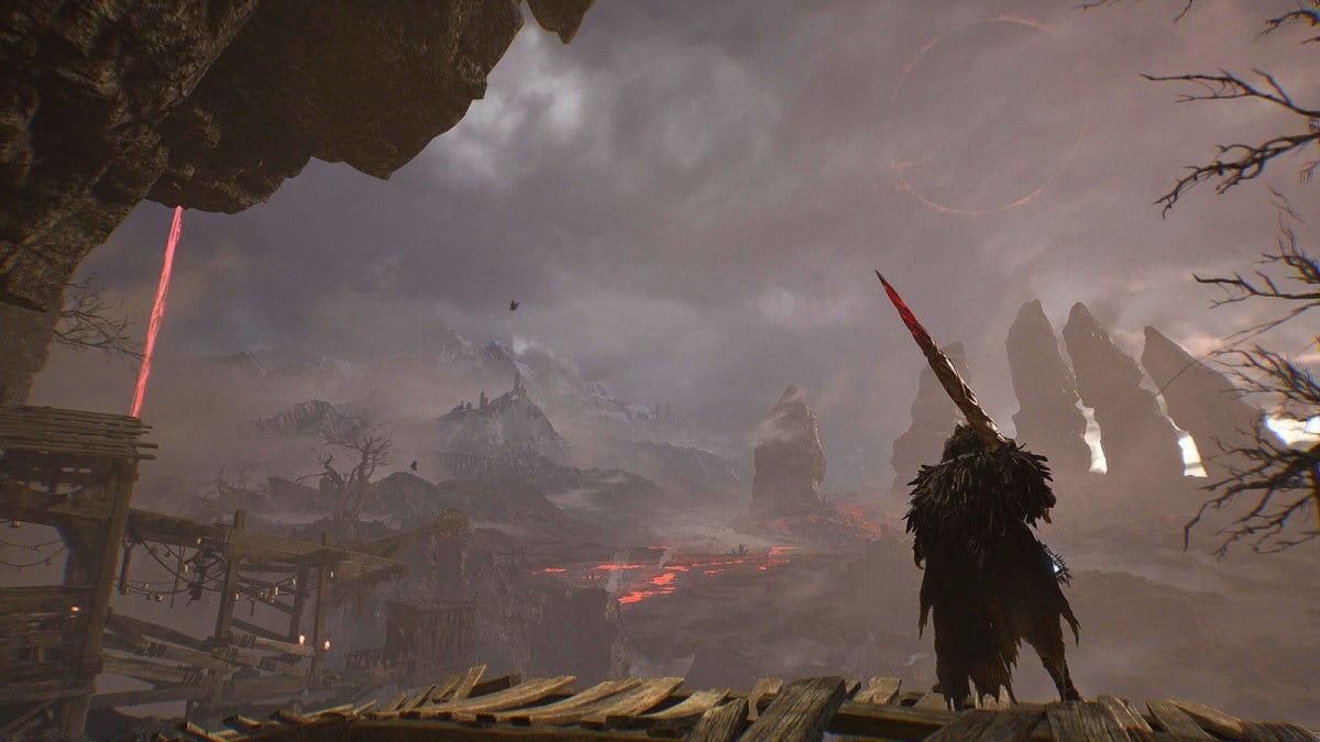 A warrior stands with a sword staring out across the plains in Lords of the Fallen.