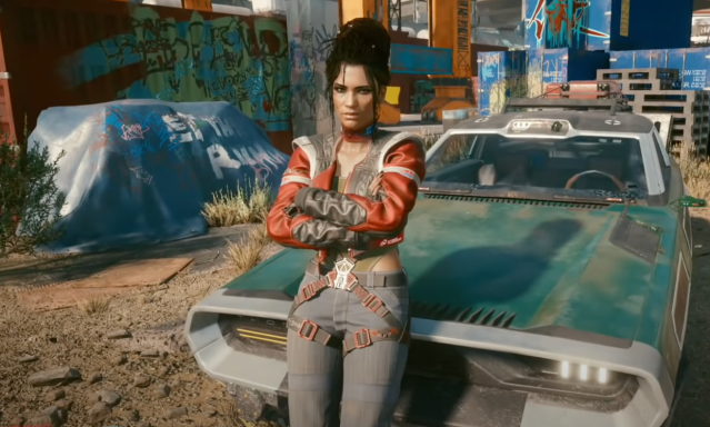 Panam Palmer leans against a car in Cyberpunk 2077. 