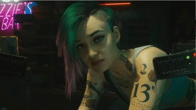 Judy from Cyberpunk 2077 stares at V (the camera). 