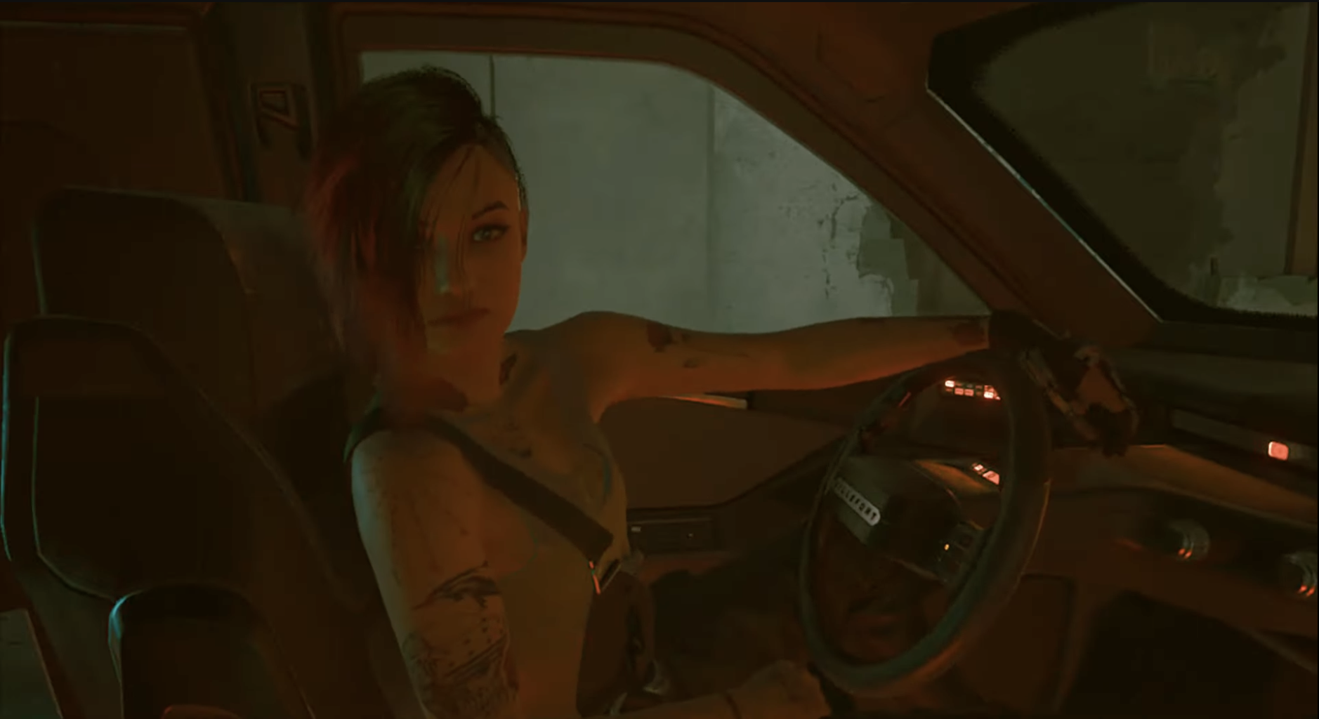 Judy looking at the player in a car in Cyberpunk 2077. 