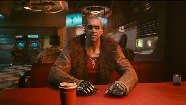 River Ward sits at a red table in a diner in the Cyberpunk 2077 mission "The Hunt". 