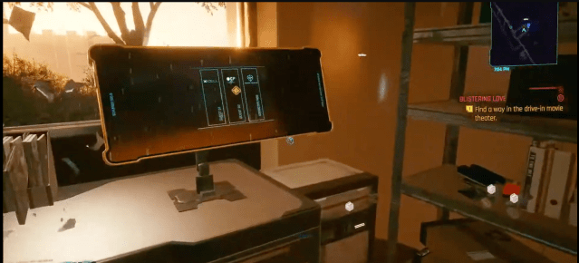 A computer on a table in a mission in Cyberpunk 2077.