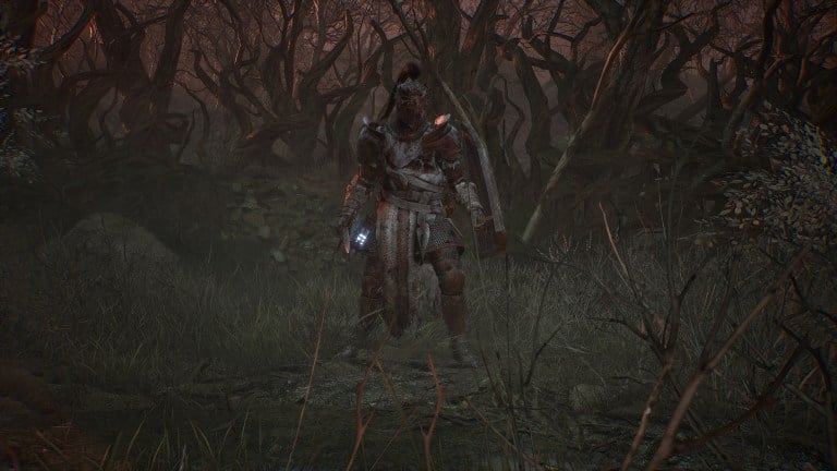 A character in Lords of the Fallen standing in a barren field.