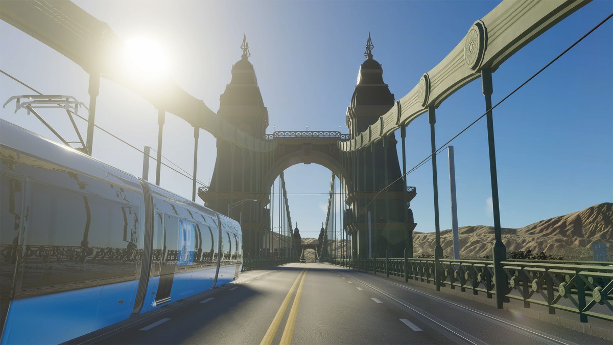 A bridge with a train moving across it is shown from the perspective of being on the bridge itself.