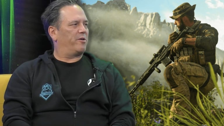 Phil Spencer sitting in a chair next to a Call of Duty character.